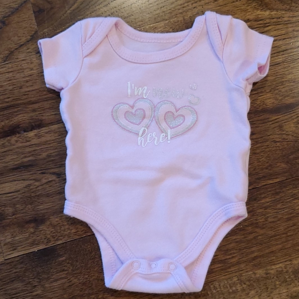 Baby girl "I'm new here" onesie is a size 0-3M